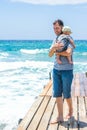 Happy parent with a child by the sea in the open air Royalty Free Stock Photo