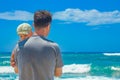 Happy parent with a child by the sea in the open air Royalty Free Stock Photo