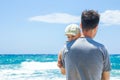 Happy parent with a child by the sea in the open air Royalty Free Stock Photo