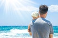 Happy parent with a child by the sea in the open air Royalty Free Stock Photo