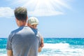 Happy parent with a child by the sea in the open air Royalty Free Stock Photo
