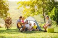 Happy parent and children enjoying camping