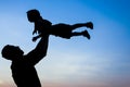 Happy parent father with baby silhouette in a park on the nature of the sunset Royalty Free Stock Photo