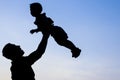Happy parent father with baby silhouette in a park on the nature of the sunset Royalty Free Stock Photo