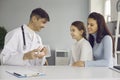 Pediatric dentist or oral hygienist teaching little child to clean teeth properly Royalty Free Stock Photo