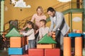 happy parents with adorable little kids playing together with colorful blocks Royalty Free Stock Photo