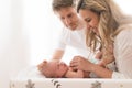 Happy parents bonding with their newborn son who is lying on changing mat at home. Royalty Free Stock Photo