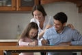 Happy parents and cheerful kid girl drawing in colored pencils Royalty Free Stock Photo