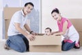 Happy parents and child play with box Royalty Free Stock Photo