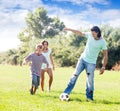 Happy parents with child playing with ball Royalty Free Stock Photo