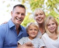 Happy, parents and children in garden for portrait outdoor in summer with love, freedom and together in nature. Family Royalty Free Stock Photo