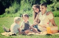 Happy parents with children having picnic outdoor Royalty Free Stock Photo