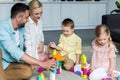 happy parents with cute little kids playing with colorful blocks Royalty Free Stock Photo