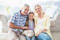 Happy parents and daughter with rabbit in living room Royalty Free Stock Photo