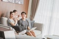 Happy parents with daughter using laptop in living room Royalty Free Stock Photo