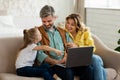 Happy Parents And Daughter Using Laptop Together At Home Royalty Free Stock Photo