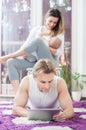 Happy parents. Father laying down on the floor and playing on tablet. Royalty Free Stock Photo