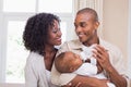 Happy parents feeding their baby boy a bottle Royalty Free Stock Photo