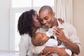 Happy parents feeding their baby boy a bottle Royalty Free Stock Photo