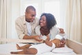 Happy parents feeding their baby boy in his crib Royalty Free Stock Photo