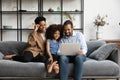 Happy parents and gen Z daughter girl using laptop Royalty Free Stock Photo