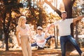 Parents have fun with their son in autumn park