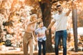 Parents have fun with their son in autumn park. Selective focus