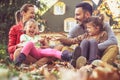 Happy parents have play with children outside. Autumn season.