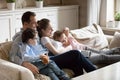 Parents cuddle with children watching kid video at laptop Royalty Free Stock Photo