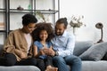 Happy parents and kid using online learning app on cellphone Royalty Free Stock Photo