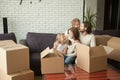 New tenants family with kids and boxes enjoying moving day