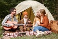 Happy parents and kids enjoying great family camping trip in nature Royalty Free Stock Photo