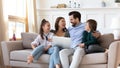 Happy parents with kids rest at home using computer Royalty Free Stock Photo