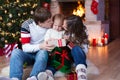 Happy parents kissing little son and giving gifts Royalty Free Stock Photo