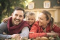 Happy parents with little girl laying on ground. Royalty Free Stock Photo