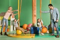 happy parents looking at kids swinging on swings in entertainment Royalty Free Stock Photo