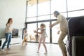 Happy family playing hide and seek game in luxury house