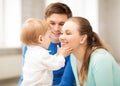 Happy parents playing with adorable baby