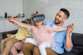 happy parents playing with kids using virtual reality headsets Royalty Free Stock Photo