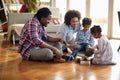 A happy parents playing with their kids on the floor at home. Family, together, love, playtime Royalty Free Stock Photo