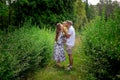 Happy parents playing with their little baby girl at the green garden Royalty Free Stock Photo