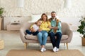 Happy Parents Posing With Daughter Sitting On Sofa At Home Royalty Free Stock Photo