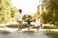 Happy parents resting with child in countryside