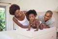 Happy parents with their baby girl on changing table Royalty Free Stock Photo