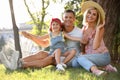 Happy parents with their child having fun on green grass. Spending time in nature Royalty Free Stock Photo