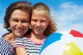 Happy parents and their child playing with a ball at the beach Royalty Free Stock Photo