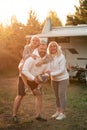 Happy parents with their child playing with a ball near their mobile home in the woods Royalty Free Stock Photo