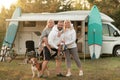 Happy parents with their child playing with a ball near their mobile home in the woods Royalty Free Stock Photo