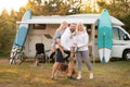 Happy parents with their child playing with a ball near their mobile home in the woods Royalty Free Stock Photo