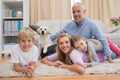 Happy parents and their children on floor with puppy Royalty Free Stock Photo